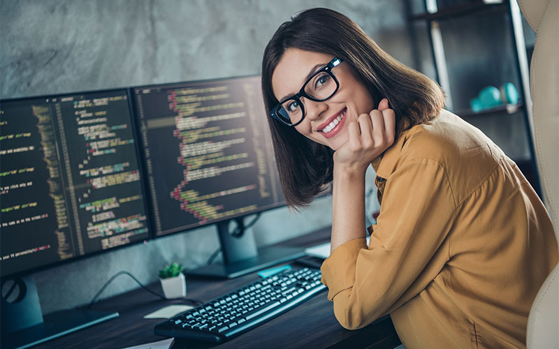 Smiling woman working at PC