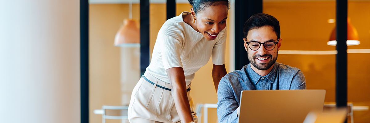 Two colleagues working on a laptop