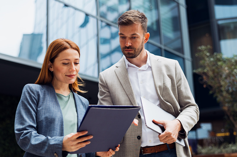 Two colleagues sharing a document
