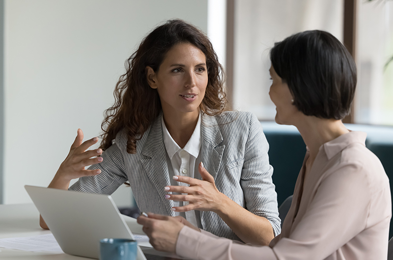 Two colleagues sharing a document
