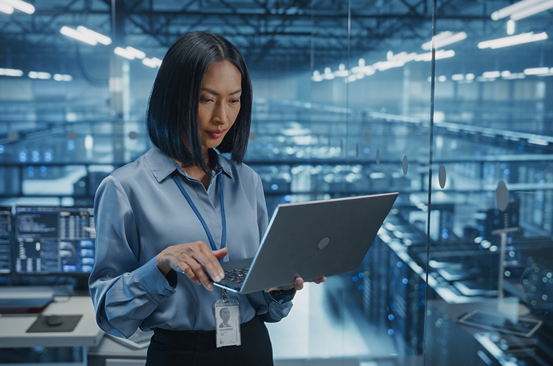 Woman holding a tablet in a data centre