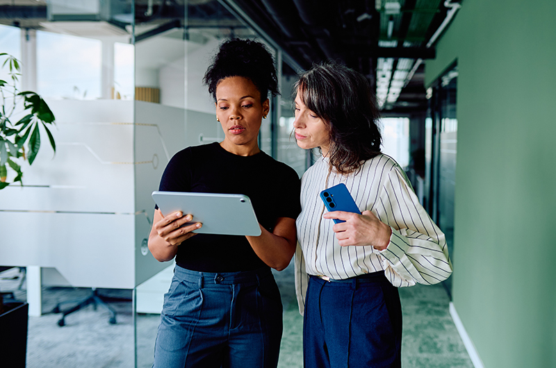 Two businesswomen working on a tablet