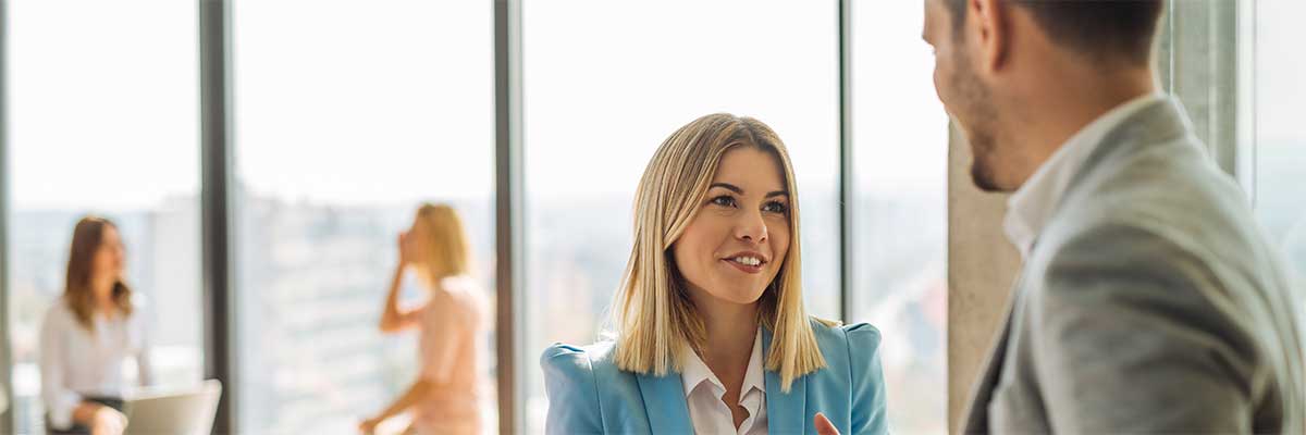 A business woman and man are talking about building resilience 