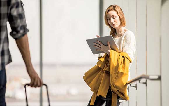 Woman using Microsoft Surface at airport