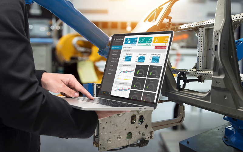 Close up of laptop using manufacturing software to interact with machine
