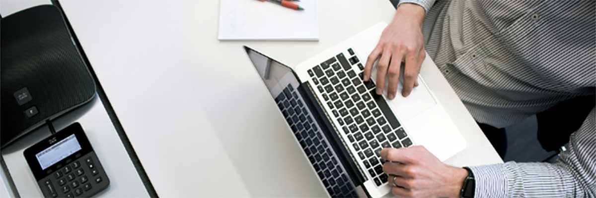 The Cloud Migration Factory A man sits behind his laptop