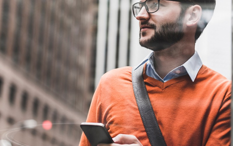 Man holding phone in the city
