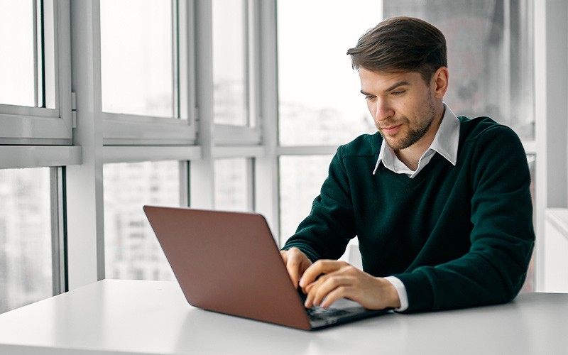 Man assessing subscription services on a laptop