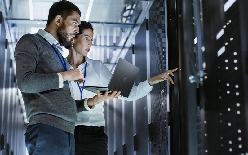 Two colleagues working in a data centre